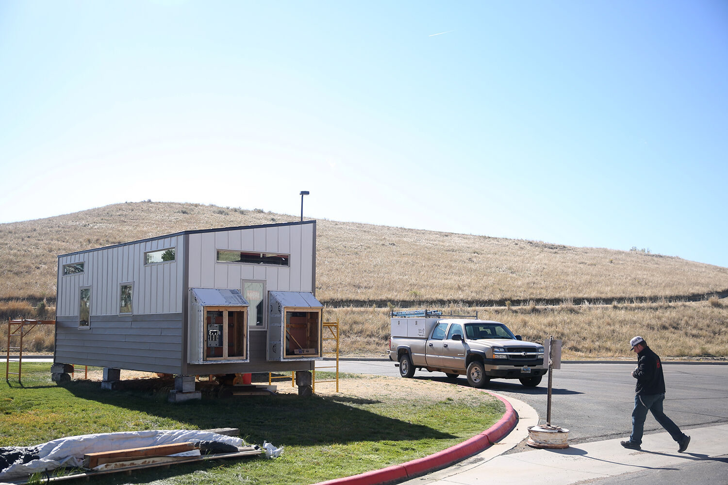 Brandon Sweeney walks back to the Tiny House from the shop